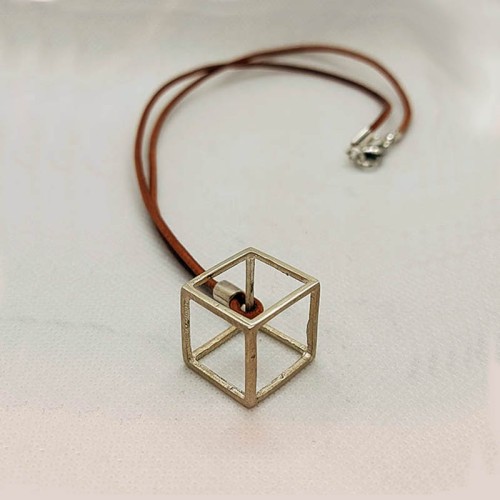 SILVER CUBE WITH LEATHER CORD.